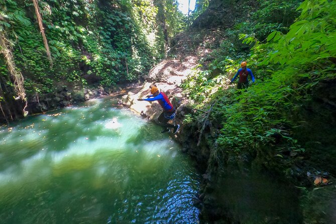 Canyoning Adventure in Sambangan Canyon - The canyon action: slides, jumps, abseils, zip-line, and swimming