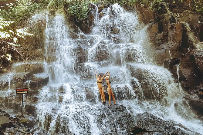 Tanah Lot Temple, Waterfall & Ubud Tour (Private & All-Inclusive) - Kanto Lampo Waterfall: black rocks and a fan-out fall